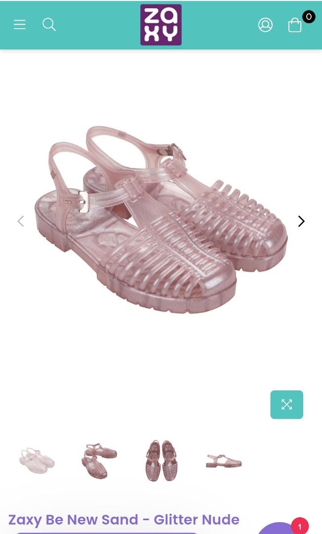 Zaxy Be New Sand - Glitter Nude Sandals (Category: Flats & Sandals) located in San Jose del Monte. Submitted by twinkletoes_ph (Listing ID 1402055593, Image 1). Description: These Zaxy sandals are a glittery nude color. They have a cage-like design with a buckle closure. The sandals appear to be unworn and come with their original box. The soles have a textured pattern for grip. The Zaxy logo is visible on the sandals and the box..