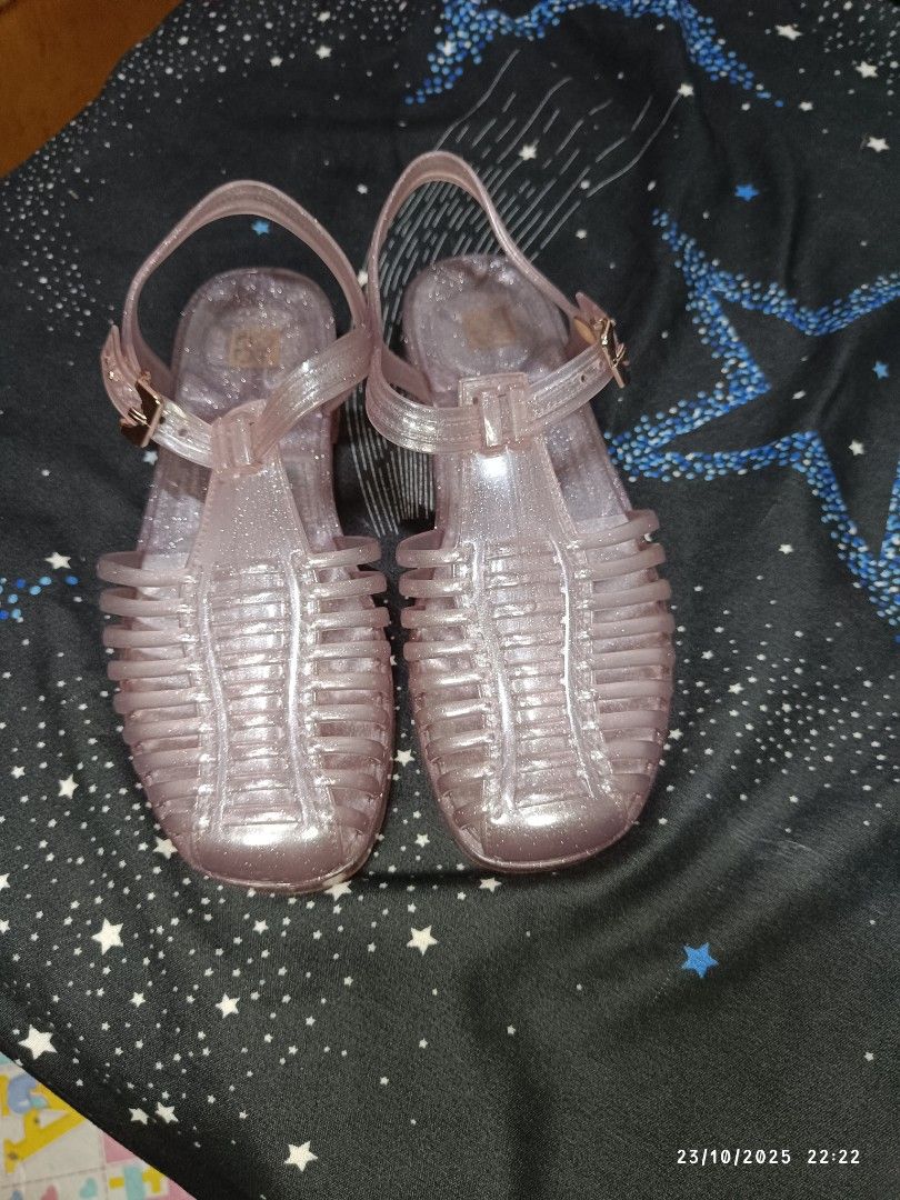 Zaxy Be New Sand - Glitter Nude Sandals (Category: Flats & Sandals) located in San Jose del Monte. Submitted by twinkletoes_ph (Listing ID 1402055593, Image 2). Description: These Zaxy sandals are a glittery nude color. They have a cage-like design with a buckle closure. The sandals appear to be unworn and come with their original box. The soles have a textured pattern for grip. The Zaxy logo is visible on the sandals and the box..