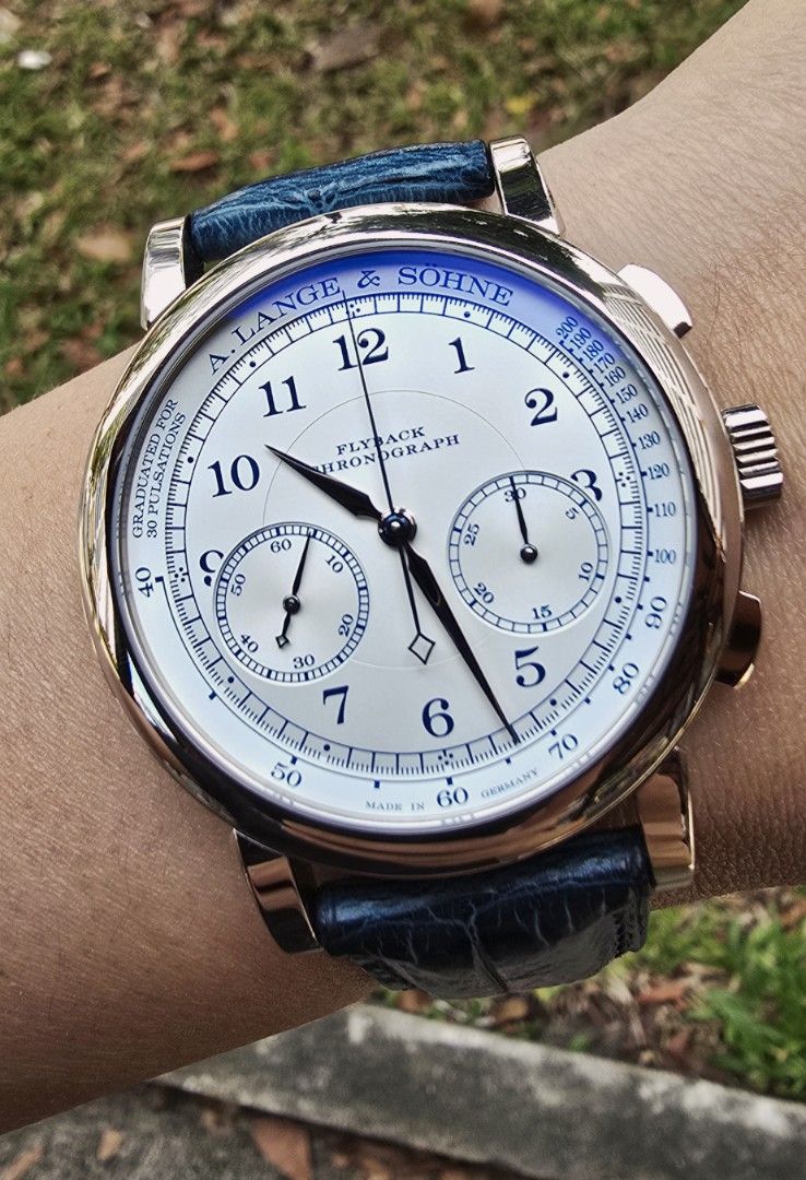 A. Lange & Söhne 1815 414.026 Flyback Chronograph Boutique Edition (Category: Watches) located in Singapore. Submitted by 1etw1 (Listing ID 1397981172, Image 2). Description: Full complete set boutique edition Under boutique warranty until mid of 2026 Mint condition piece 414.026 - A. Lange & Söhne Flyback Chronograph watch dated 2023 - White dial with blue accents - Black dark blue original leather strap - Chronograph flyback function - A timele