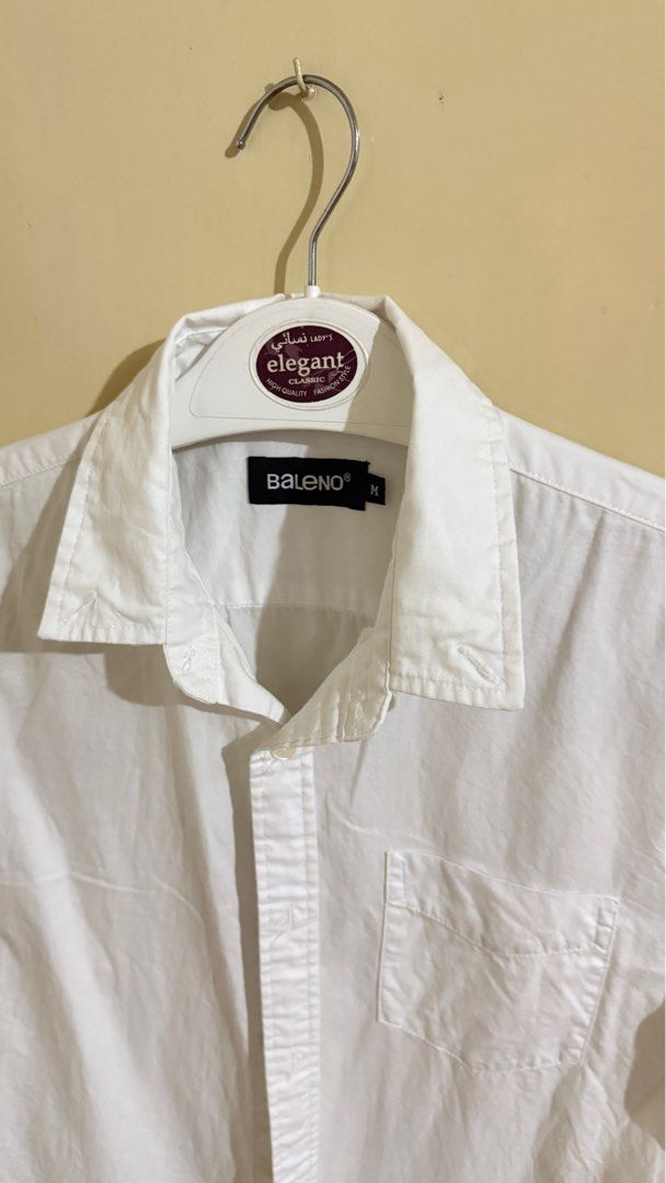 Baleno Short Sleeve Polo - White (Category: Tshirts & Polo Shirts ) located in Bacoor. Submitted by patrickluwis (Listing ID 1407161910, Image 2). Description: Baleno white short sleeve shirt, size medium. No color fading. Collared neckline, chest pocket, and button closure. Lightweight and versatile for casual or semi-formal wear..