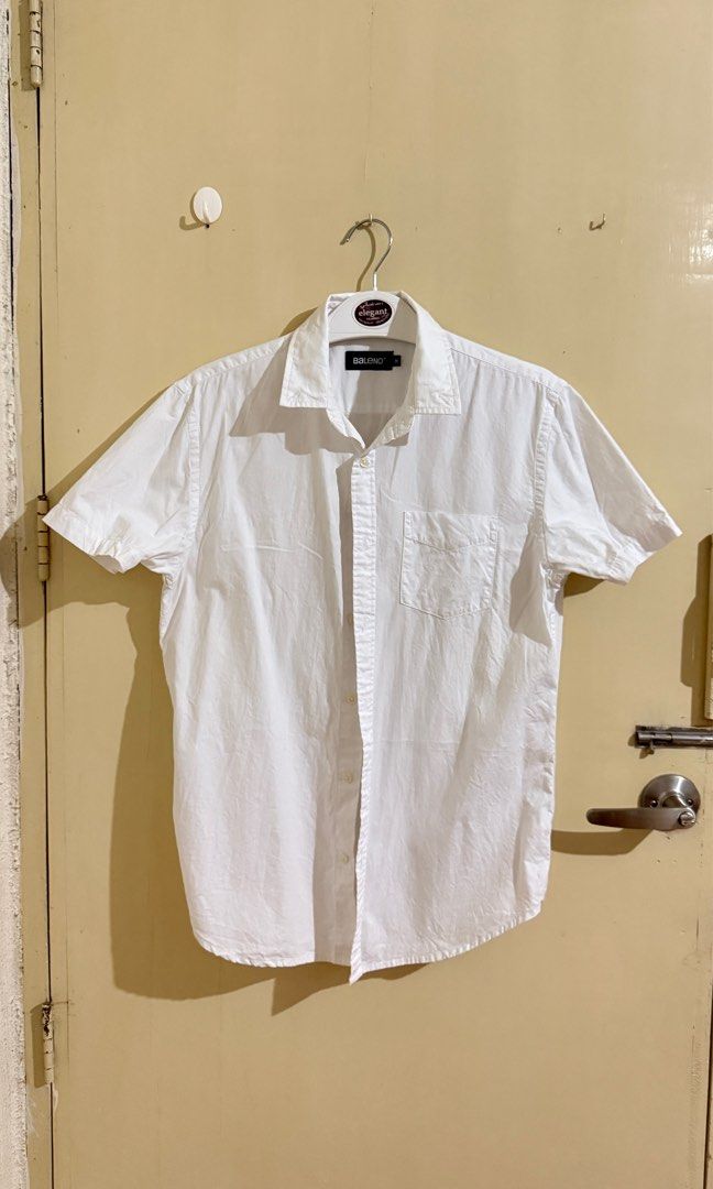 Baleno Short Sleeve Polo - White (Category: Tshirts & Polo Shirts ) located in Bacoor. Submitted by patrickluwis (Listing ID 1407161910, Image 1). Description: Baleno white short sleeve shirt, size medium. No color fading. Collared neckline, chest pocket, and button closure. Lightweight and versatile for casual or semi-formal wear..
