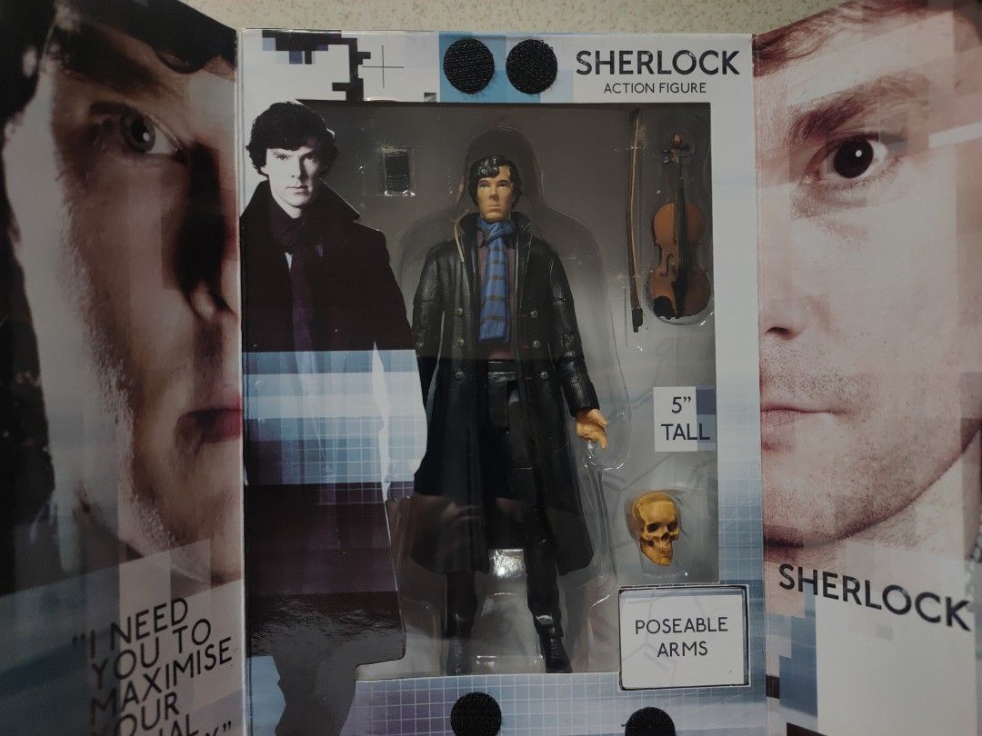 BBC Sherlock Action Figure (5") (Category: Figurines & Statues) located in Manila. Submitted by beacko (Listing ID 1407024447, Image 1). Description: Brand new BBC Sherlock Holmes action figure in the likeness of Benedict Cumberbatch. - Approximately 5 inches tall - Includes accessories: phone, violin, skull - Features poseable arms - Packaged in a box with Sherlock Holmes images and a cool 221B door with velcro closure. - Manufactured by Undergr