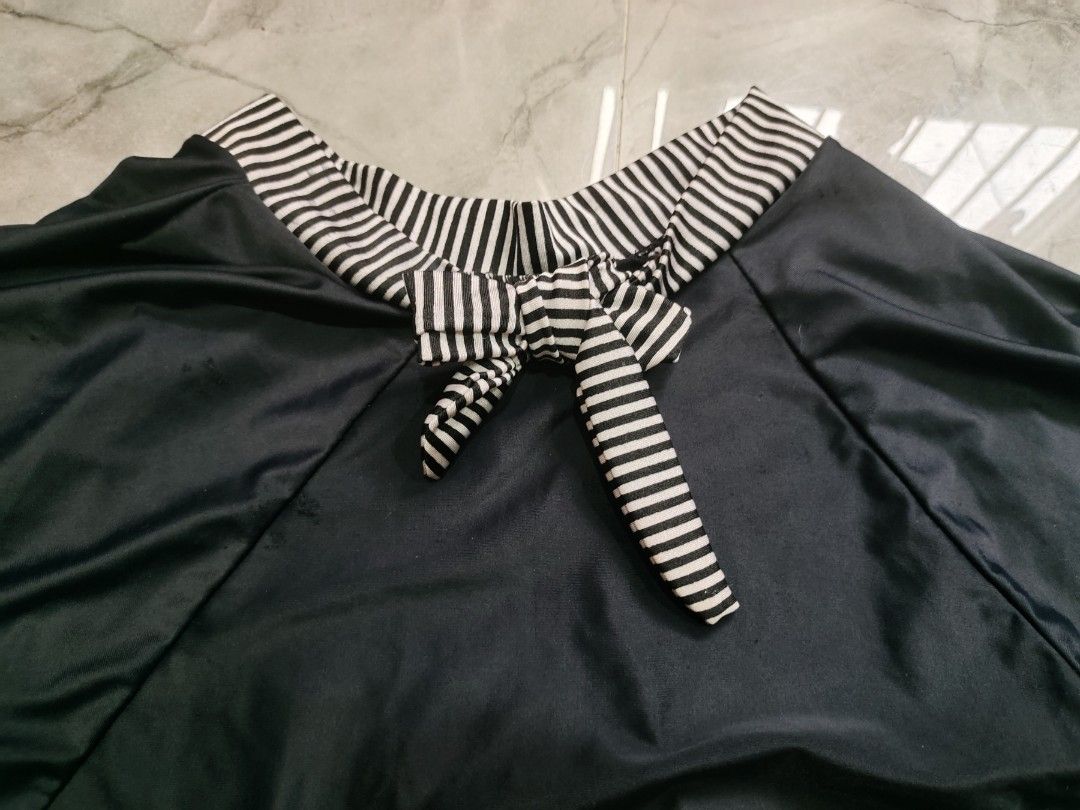 Black Tianzi Skirt with Bow (Category: Skirts) located in Manila. Submitted by fleurin (Listing ID 1407004820, Image 2). Description: - Tianzi skirt - Unique bow detail - Black and white striped trim - Smooth, dark fabric - Stylish design.