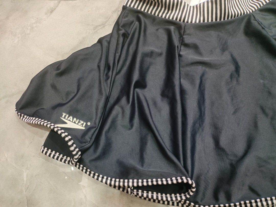 Black Tianzi Skirt with Bow (Category: Skirts) located in Manila. Submitted by fleurin (Listing ID 1407004820, Image 3). Description: - Tianzi skirt - Unique bow detail - Black and white striped trim - Smooth, dark fabric - Stylish design.
