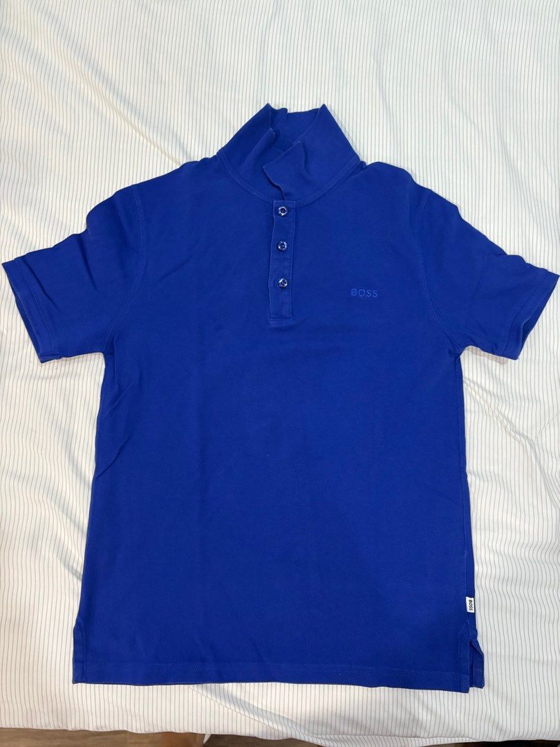BOSS Blue Polo Shirt (Category: Babies & Kids Fashion) located in Quezon City. Submitted by ccamp17 (Listing ID 1407132676, Image 1). Description: - Brand: BOSS - Color: Vibrant Blue - Style: Polo shirt with high collar and three buttons - Sleeves: Short - Details: Embroidered BOSS logo on chest - Size: 12-XS - Condition: Good.