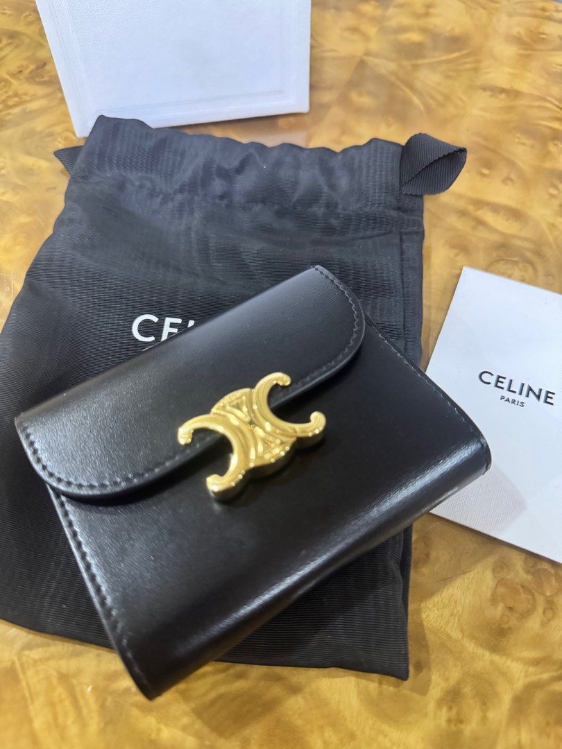 Celine Triomphe Small Wallet Black Authentic (Category: Luxury Bags & Wallets) located in Makati City. Submitted by happyprelovedph (Listing ID 1407017135, Image 3). Description: - Authentic Celine Triomphe small wallet - Color: Black - Gold-tone Triomphe clasp - Includes original box, dust bag, and care card - Interior: Multiple card slots and coin compartment - Material: Smooth leather - Perfect for everyday use -Used once.