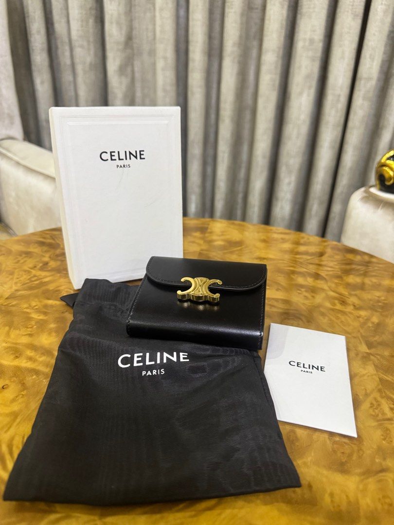 Celine Triomphe Small Wallet Black Authentic (Category: Luxury Bags & Wallets) located in Makati City. Submitted by happyprelovedph (Listing ID 1407017135, Image 1). Description: - Authentic Celine Triomphe small wallet - Color: Black - Gold-tone Triomphe clasp - Includes original box, dust bag, and care card - Interior: Multiple card slots and coin compartment - Material: Smooth leather - Perfect for everyday use -Used once.