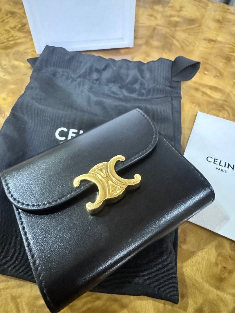 Celine Triomphe Small Wallet Black Authentic (Category: Luxury Bags & Wallets) located in Makati City. Submitted by happyprelovedph (Listing ID 1407017135, Image 2). Description: - Authentic Celine Triomphe small wallet - Color: Black - Gold-tone Triomphe clasp - Includes original box, dust bag, and care card - Interior: Multiple card slots and coin compartment - Material: Smooth leather - Perfect for everyday use -Used once.