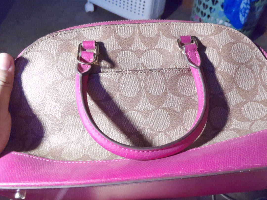 Coach Dome Handbag with pink trim (Category: Luxury Bags & Wallets) located in San Mateo. Submitted by febikeyt (Listing ID 1407087036, Image 2). Description: - Authentic Coach handbag - Dome shape with pink base and handles - Signature Coach pattern on the main body - Bright pink interior - Medium size - Top handle design - Coach logo visible RFS: For extra school funds ++rarely used.