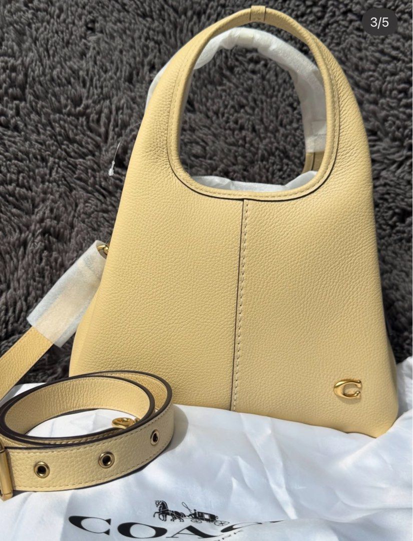 Coach Lana 23 Bag in Moonlight (Category: Luxury Bags & Wallets) located in Makati City. Submitted by abbyg22 (Listing ID 1407066868, Image 3). Description: - Coach Ergo Shoulder Bag - Pale yellow color - Detachable shoulder strap - Top handle - Stitched design detail - Coach logo on front - Includes dust bag.