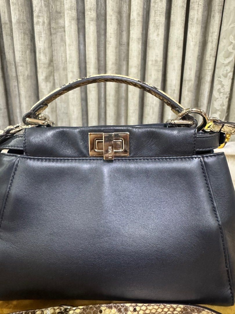 Fendi Mini Peekaboo with Python Top Handle Authentic (Category: Luxury Bags & Wallets) located in Makati City. Submitted by happyprelovedph (Listing ID 1407017475, Image 2). Description: - Authentic Fendi Peekaboo Iconic Mini - Black leather exterior - Snakeskin top handle and shoulder strap - Navy blue interior - Turn-lock closure - Silver-tone hardware - Structured shape.