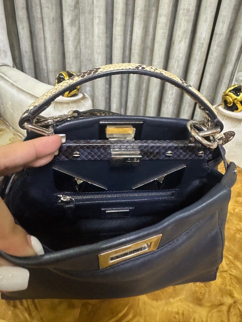 Fendi Mini Peekaboo with Python Top Handle Authentic (Category: Luxury Bags & Wallets) located in Makati City. Submitted by happyprelovedph (Listing ID 1407017475, Image 3). Description: - Authentic Fendi Peekaboo Iconic Mini - Black leather exterior - Snakeskin top handle and shoulder strap - Navy blue interior - Turn-lock closure - Silver-tone hardware - Structured shape.
