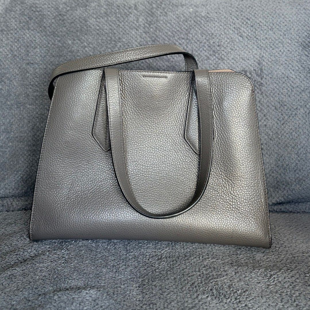 Furla Grey Leather Tote Bag (Category: Luxury Bags & Wallets) located in Makati City. Submitted by holareich (Listing ID 1407079140, Image 3). Description: - Furla grey tote bag - Structured design - Top handles - Secure zip and snap closures - Protective metal feet - Spacious interior - Perfect for everyday use Original. Money back guarantee. Comes with original Furla dust bag. Dimensions (inches): 10 x 14 x 6.