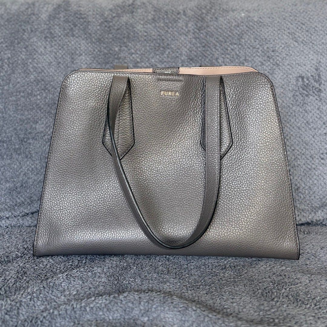 Furla Grey Leather Tote Bag (Category: Luxury Bags & Wallets) located in Makati City. Submitted by holareich (Listing ID 1407079140, Image 1). Description: - Furla grey tote bag - Structured design - Top handles - Secure zip and snap closures - Protective metal feet - Spacious interior - Perfect for everyday use Original. Money back guarantee. Comes with original Furla dust bag. Dimensions (inches): 10 x 14 x 6.