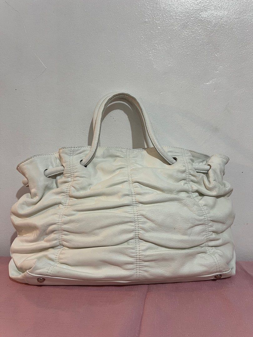 Furla White Leather Tote Bag (Category: Luxury Bags & Wallets) located in Tacloban City. Submitted by classy_luxury (Listing ID 1407127185, Image 3). Description: Sale ‼️ Sale ‼️ - Authentic Furla tote bag - White leather - Ruched design - Double top handles - Magnetic snap closure - Interior zip pocket - Furla logo - Metal feet for protection - Made in Tunisia.