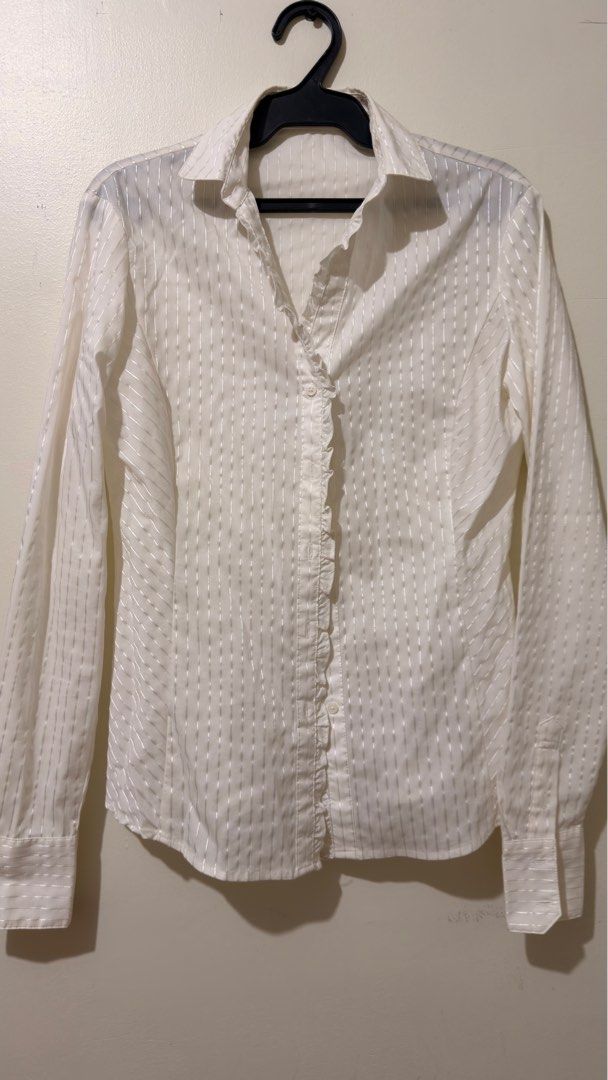 G2000 WOMAN White Polo (Category: Blouses) located in Quezon City. Submitted by declutterw_v (Listing ID 1407163986, Image 1). Description: - C2GOOD WOMAN white blouse - Striped design - Ruffled front detail - Long sleeves - Classic collar - Size 32 - Suitable for casual and formal wear.