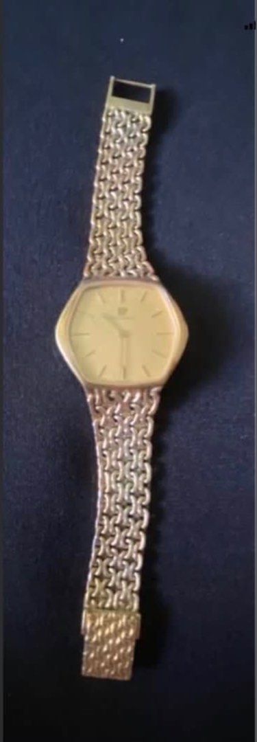 Girard-Perregaux Gold Watch (Category: Luxury Watches) located in Paranaque City. Submitted by bloo_berry (Listing ID 1407191345, Image 3). Description: Elegant Girard-Perregaux watch with a gold-toned hexagonal face and a matching gold chain-link strap. The watch features a simple, clean dial with stick hour markers and the brand's logo. The back of the watch is also gold-toned. Bracelet approximately 6 inches. Selling as is. ₱24,850 This is a v