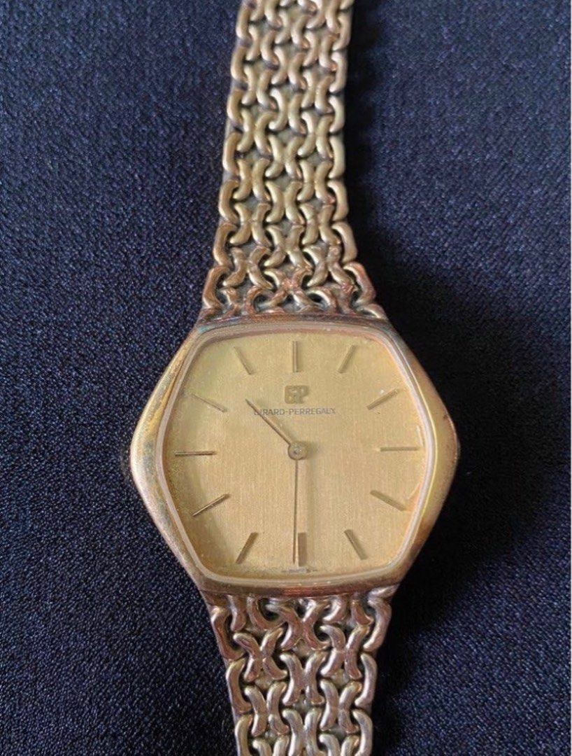 Girard-Perregaux Gold Watch (Category: Luxury Watches) located in Paranaque City. Submitted by bloo_berry (Listing ID 1407191345, Image 2). Description: Elegant Girard-Perregaux watch with a gold-toned hexagonal face and a matching gold chain-link strap. The watch features a simple, clean dial with stick hour markers and the brand's logo. The back of the watch is also gold-toned. Bracelet approximately 6 inches. Selling as is. ₱24,850 This is a v
