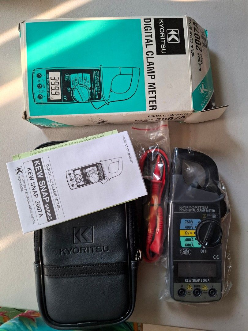 Kyoritsu Digital Clamp Meter KEW SNAP 2007A (Category: Construction Tools & Equipment) located in Manila. Submitted by aileencaya83136 (Listing ID 1407172299, Image 1). Description: Kyoritsu Digital Clamp Meter KEW SNAP 2007A. Includes the meter itself, a carrying case, test leads, and the instruction manual. The meter has a digital display and a dial for selecting different measurement ranges. The box indicates it is a digital AC clamp meter. Th