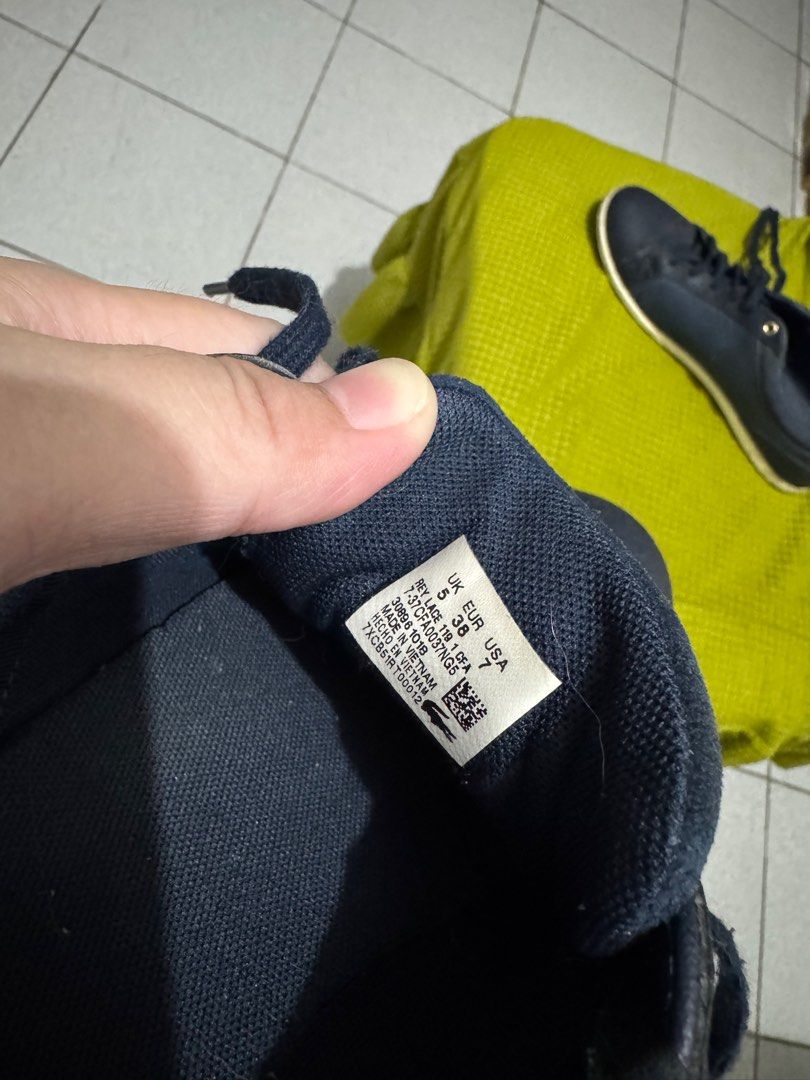 Lacoste Navy Blue Sneakers Original (Category: Sneakers) located in Manila. Submitted by mitchmacy (Listing ID 1407177036, Image 2). Description: - Navy blue Lacoste sneakers - Gold accent on the heel - Size: UK 5, EUR 38, US 7 - Made in Vietnam -Bought in Japan - White sole - Lace-up closure - Lacoste logo on the side - With visible damage natago ng matagal almost hindi nagamit sayang (wala pang 10times nagamit) -still nego.