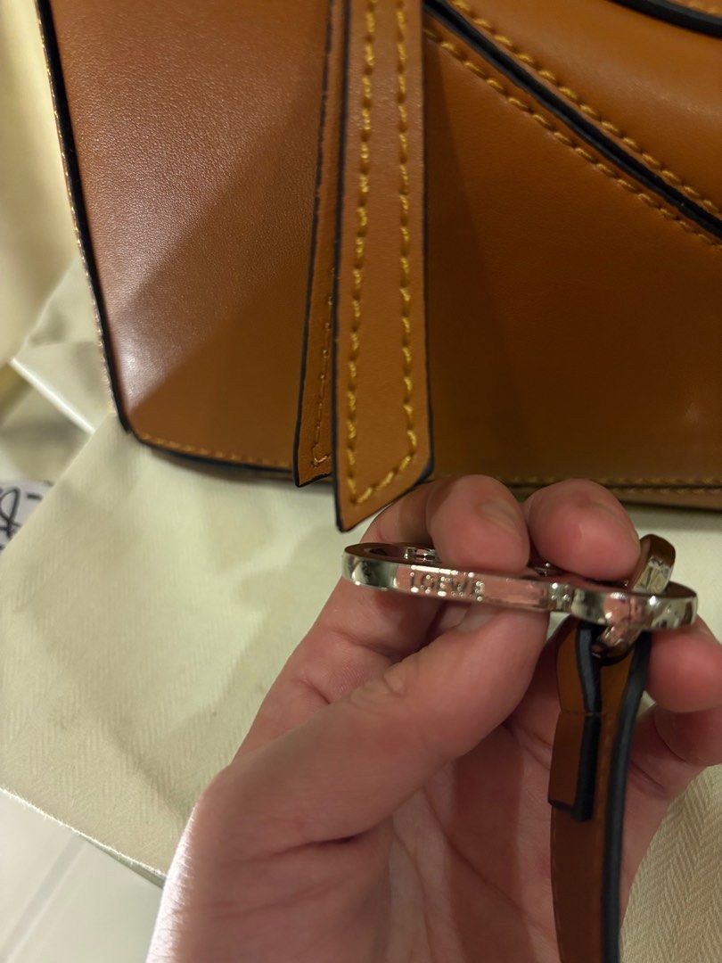 Vintage Loewe Puzzle Bag - Tan (Category: Luxury Bags & Wallets) located in Manila. Submitted by pursonalshopper (Listing ID 1407184490, Image 3). Description: Loewe Small Puzzle Bag Bought from Hongkong. It pre loved. COMPLETE INCLUSIONS: ✅Dustbag ✅Box & paperbag ✅Extra Loewe Sling strap ✅Authenticity card Dimensions: approximately 24 cm (width) x 16.5 cm (height) x 10.5 cm (depth), or about 9.4 x 6.5 x 4.1 inches ✈️WE SHIP NATIONWIDE ✅SAME DAY 