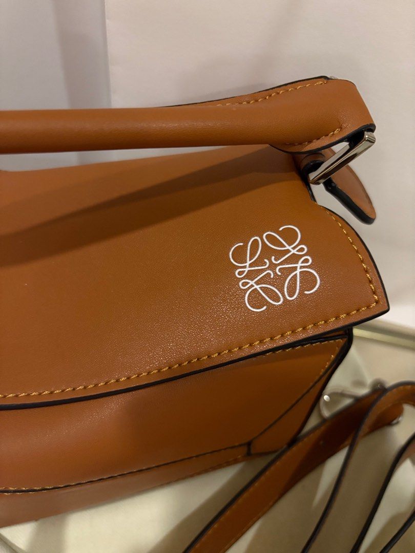 Vintage Loewe Puzzle Bag - Tan (Category: Luxury Bags & Wallets) located in Manila. Submitted by pursonalshopper (Listing ID 1407184490, Image 2). Description: Loewe Small Puzzle Bag Bought from Hongkong. It pre loved. COMPLETE INCLUSIONS: ✅Dustbag ✅Box & paperbag ✅Extra Loewe Sling strap ✅Authenticity card Dimensions: approximately 24 cm (width) x 16.5 cm (height) x 10.5 cm (depth), or about 9.4 x 6.5 x 4.1 inches ✈️WE SHIP NATIONWIDE ✅SAME DAY 