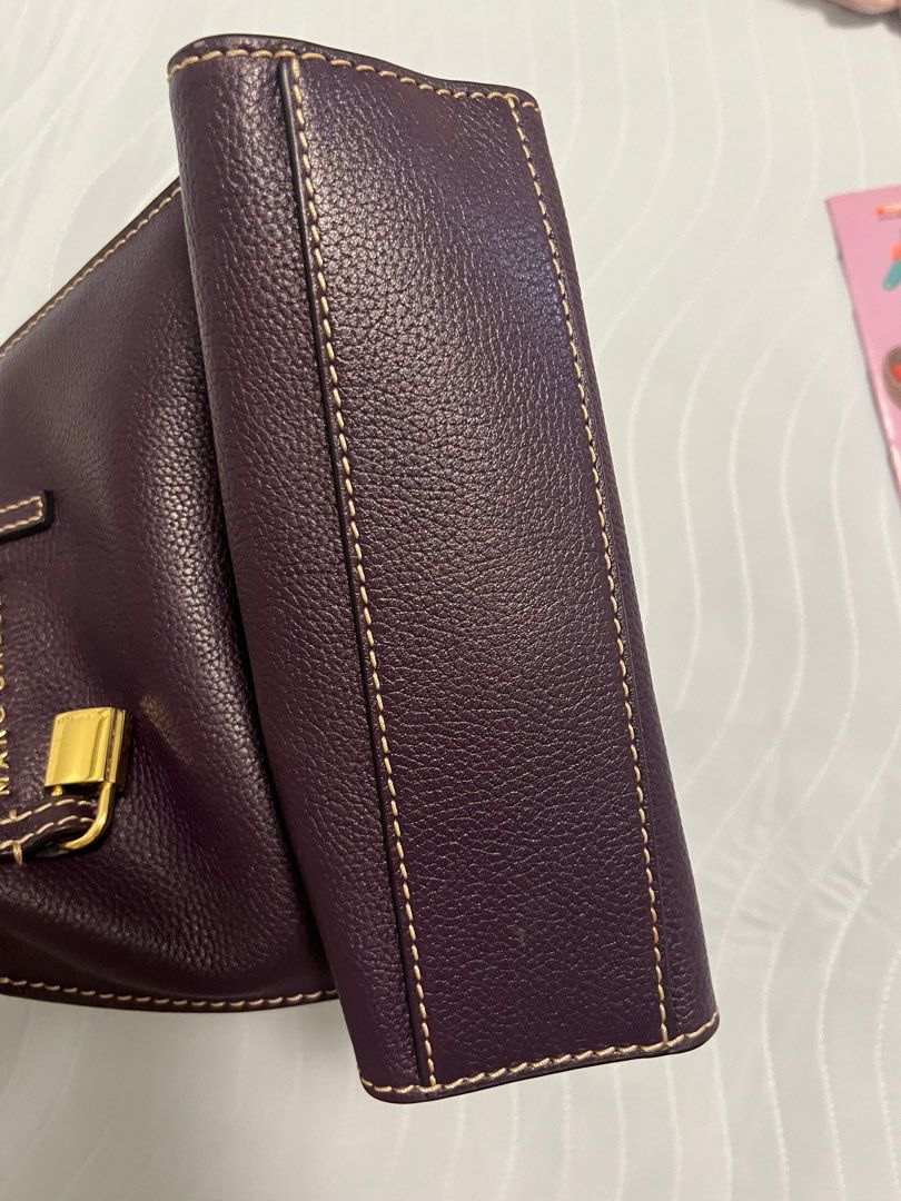 Marc Jacobs The Grind Mini Tote Bag (Category: Luxury Bags & Wallets) located in Manila. Submitted by leejessica01548 (Listing ID 1407115110, Image 3). Description: - Authentic Marc Jacobs Mini Tote Bag - Color: Deep purple exterior, yellow interior - Features: Top zipper closure, detachable shoulder strap, gold-tone padlock - Includes: Dust bag - Material: Textured leather - Stitching: Light cream color.