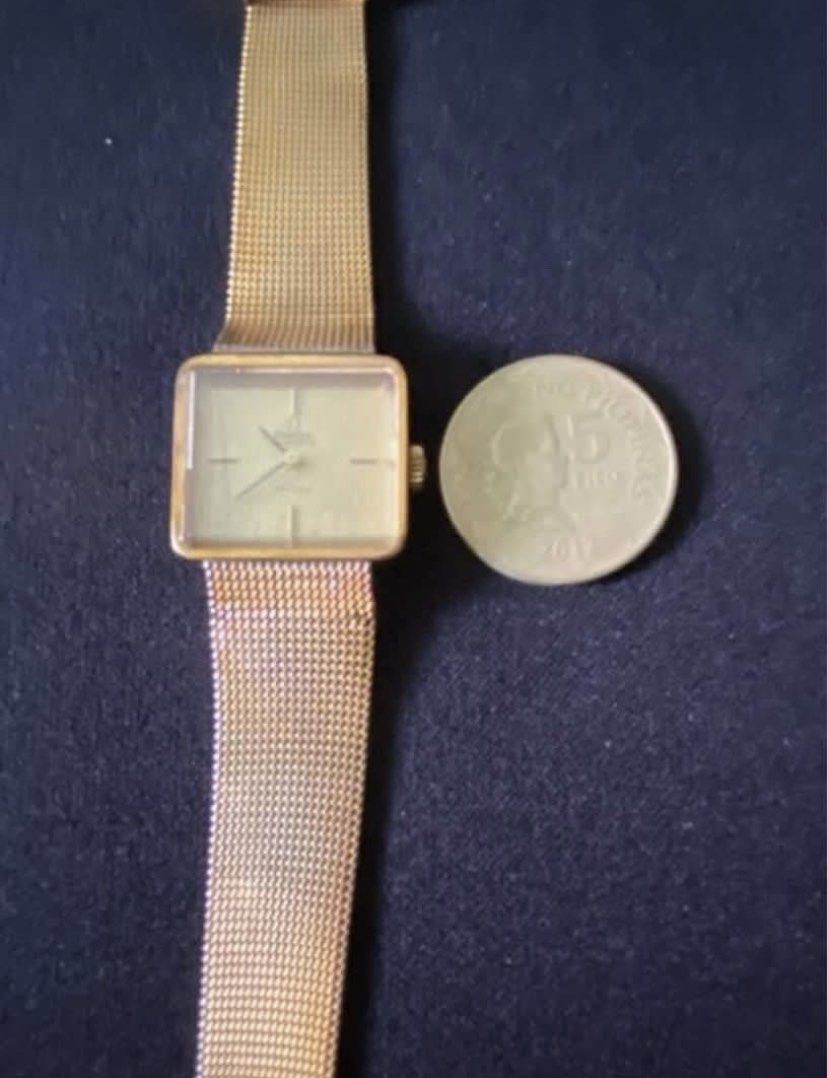 Omega De Ville Automatic Gold Watch (Category: Luxury Watches) located in Paranaque City. Submitted by bloo_berry (Listing ID 1407191152, Image 3). Description: Vintage Omega De Ville automatic watch with a gold-toned square dial and mesh strap. Features a gold-colored case and a classic design. The watch has a visible Omega logo and De Ville inscription on the dial. The watch has a crown on the side for time adjustment. Bracelet adjustable up to