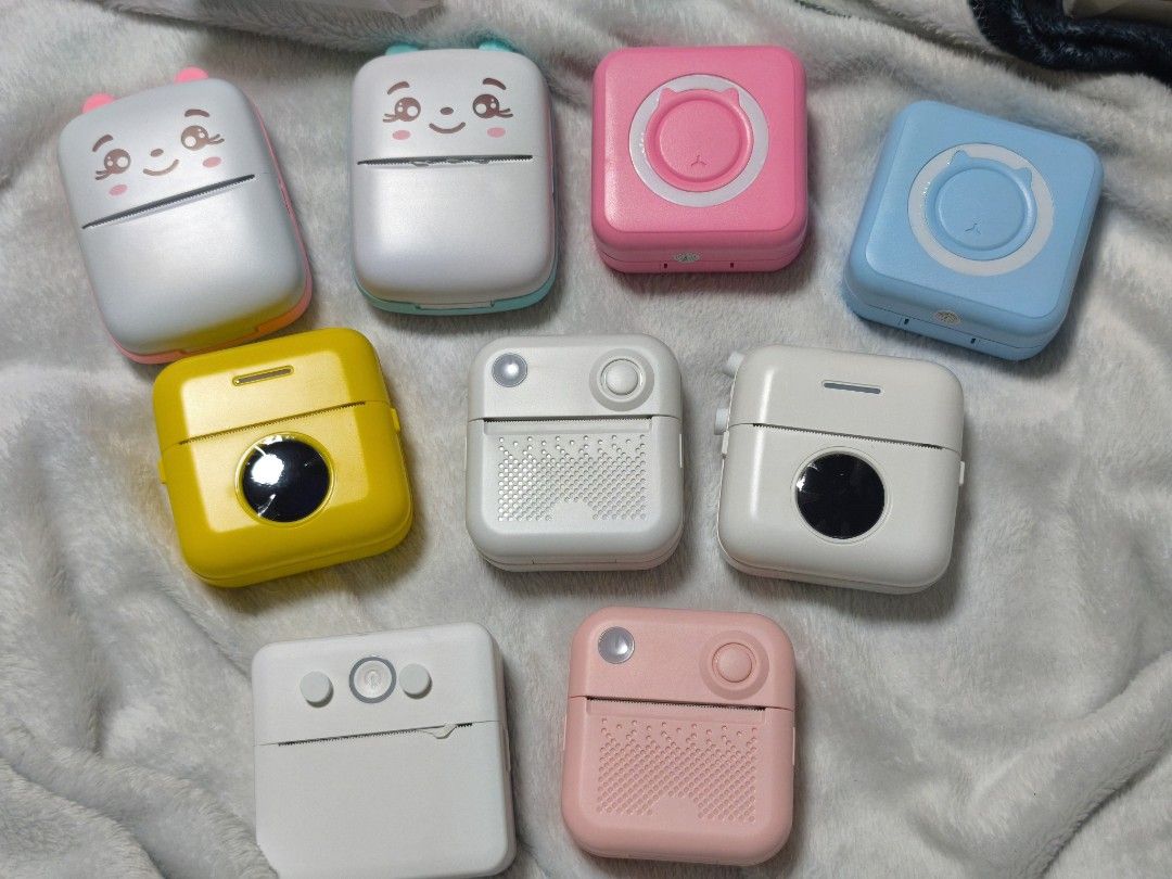 Portable Mini Printer - Various Colors (Category: Printers, Scanners & Copiers) located in Quezon City. Submitted by heramisu (Listing ID 1407179148, Image 1). Description: Cute and compact mini printer available in various colors. Features a simple design with easy-to-use buttons. Perfect for printing small photos or notes on the go. Several units are available. Colors include white, pink, yellow, and blue. Some units have cute animal designs. G