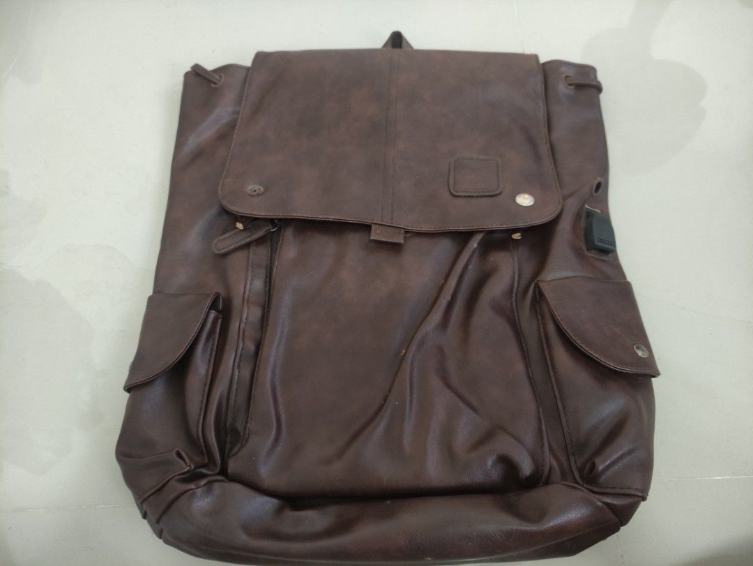 PRELOVED Men Brown Korean Rugged Leather Backpack Rucksack (Category: Backpacks) located in Quezon City. Submitted by thetimelessfinds (Listing ID 1406998615, Image 3). Description: Selling my preloved leather backpack. The item was lightly used for weeks and is still in good condition. The only issue is the broken zipper of the pouch inside the main compartment and the metal cap in front of the bag. The item can be shipped, however, the buyer wi
