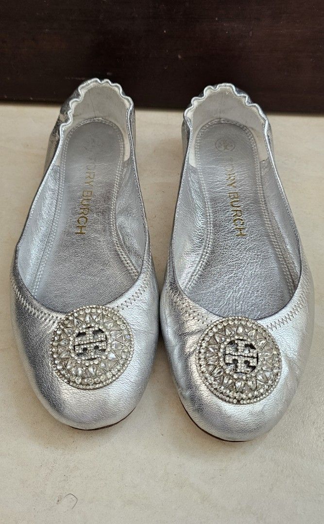 Preloved Tory Burch Silver Flats with Embellishments (Category: Flats & Sandals) located in Cebu City. Submitted by everythingonearth (Listing ID 1407059426, Image 1). Description: - Tory Burch silver flats - Size: 7.5M - Round toe design - Decorative embellishment - Leather sole - Tory Burch logo visible - Signs of wear on soles.