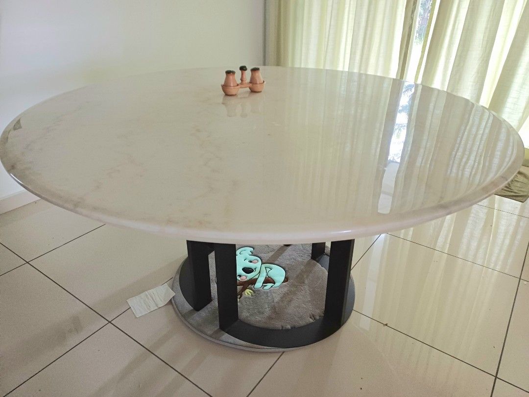 Solid Round Marble Dining Table (Category: Tables & Sets) located in Puchong. Submitted by derricklau95 (Listing ID 1407151477, Image 1). Description: This round, white marble table features a sleek polished surface with beautiful natural veining, bringing a clean and modern look to any space. Designed with a strong steel base for excellent stability, it comfortably accommodates more than 6 seaters. Perfect for dining rooms, meeting areas, or spa
