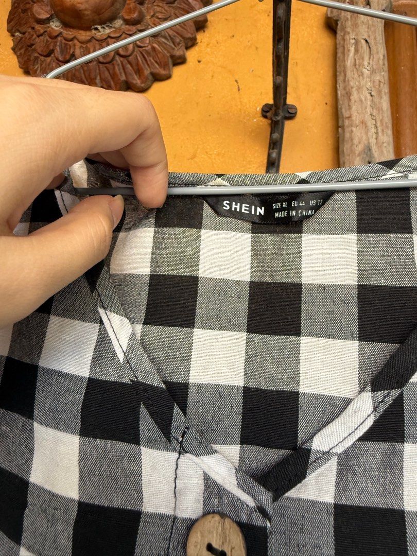 SHEIN Black and White Gingham Dress (Category: Dresses) located in Las Pinas. Submitted by btrcm. (Listing ID 1407074877, Image 2). Description: - Black and white gingham pattern - V-neckline - Button-down front - Short sleeves - Tiered skirt - Size: XL - Made in China.