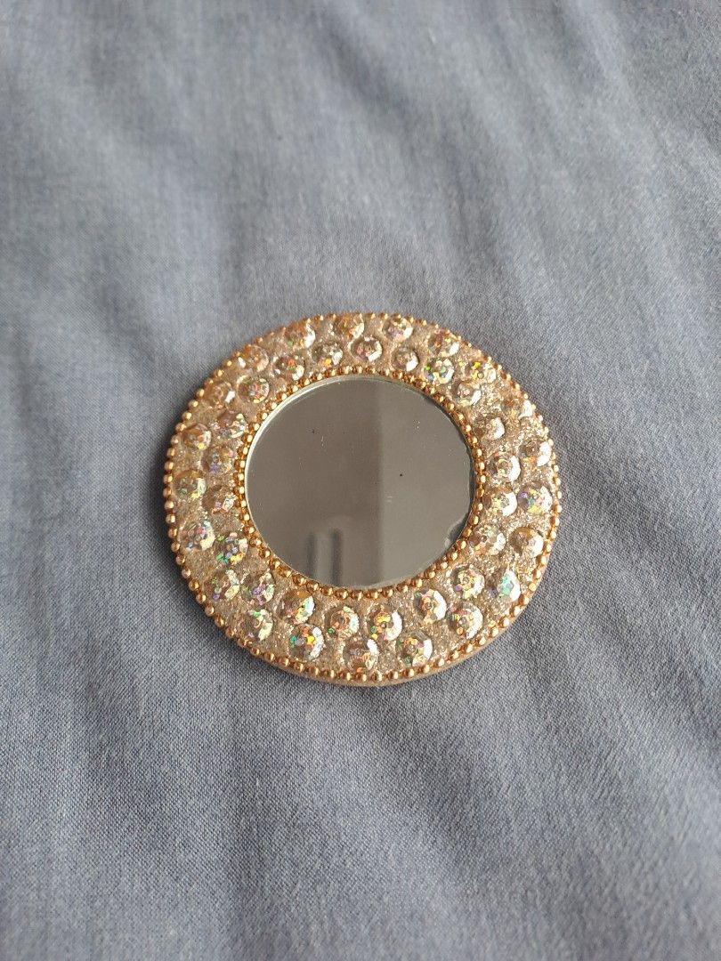 Vintage Round Mirror with Rhinestones (Category: Mirrors) located in Manila. Submitted by joanbalde39643 (Listing ID 1407083970, Image 2). Description: - Vintage round mirror - Gold-toned frame - Adorned with sparkling rhinestones - Small, circular reflective surface - Gold-toned back - Ideal for makeup or decoration.