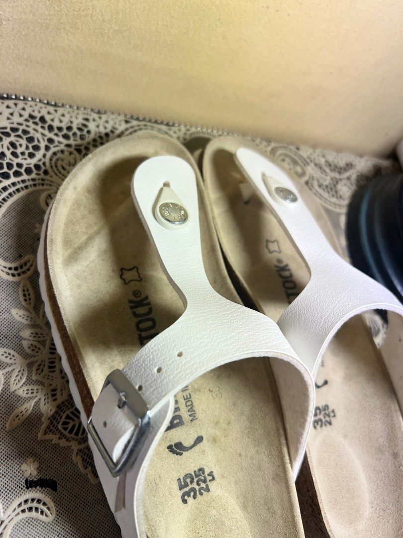 Birkenstock Gizeh Birko-Flor White Sandals (Category: Flats & Sandals) located in Makati City. Submitted by giftidea123 (Listing ID 1402142975, Image 3). Description: White Birkenstock Gizeh sandals. Features a thong strap design with a buckle closure. The footbed is made of cork. The size is 35, equivalent to 225mm. The sandals are white in color. Made in Germany. Selling for 4050 neverbeen used Issue : Stain on foot bed .