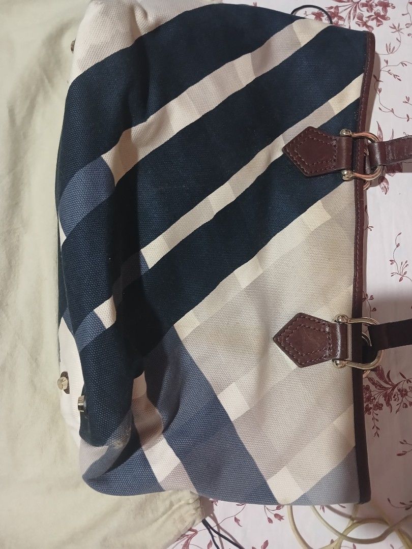 Burberry Checkered Tote Bag (Category: Luxury Bags & Wallets) located in Marikina City. Submitted by laila15 (Listing ID 1402278447, Image 2). Description: - Authentic Burberry tote bag - Classic checkered pattern (blue, white, beige) - Brown leather handles and trim - Includes dust bag with Burberry logo - Metal feet on the bottom Available .