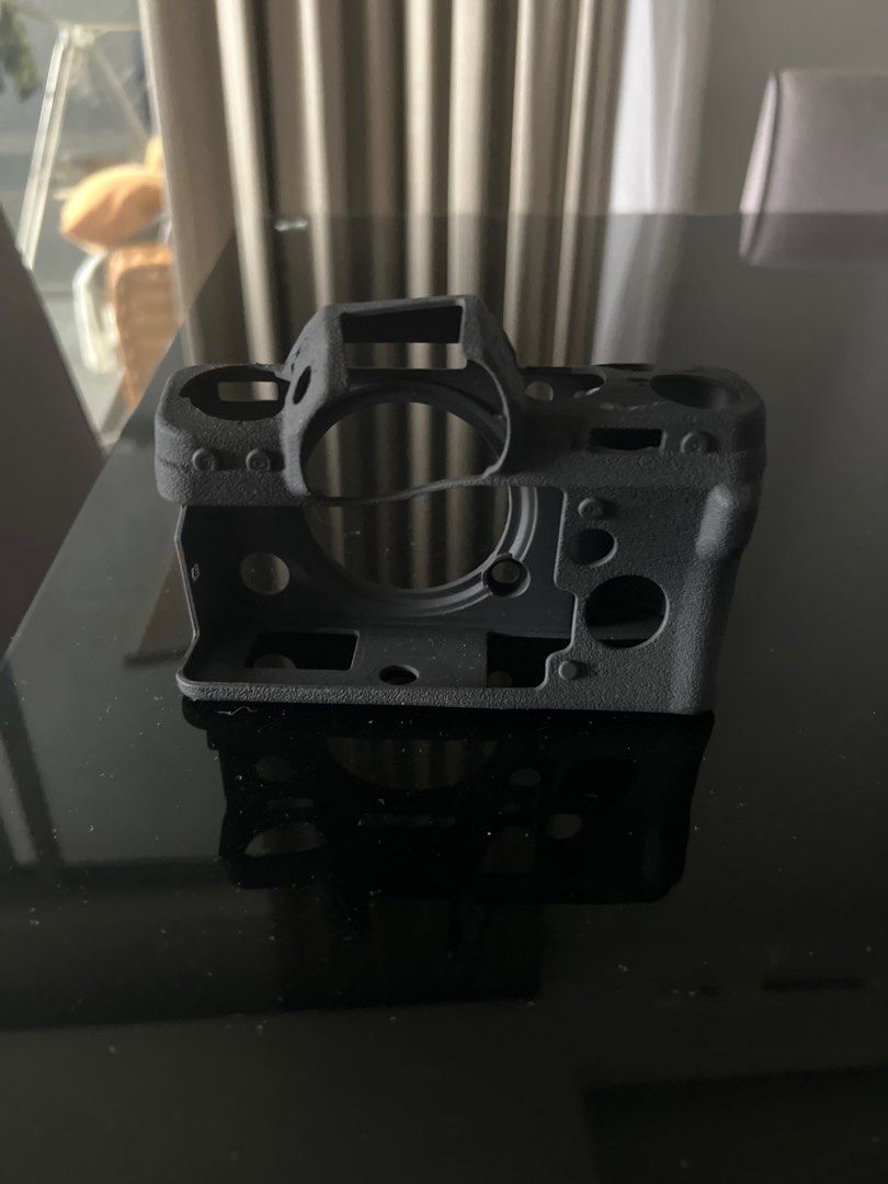 Camera Body Shell (Category: Cameras) located in Kuala Lumpur. Submitted by dkxxl (Listing ID 1402192363, Image 2). Description: - plastic body shel for xt-4 fujifilm - Gray color - Designed to hold camera components - Includes openings for lens and buttons.