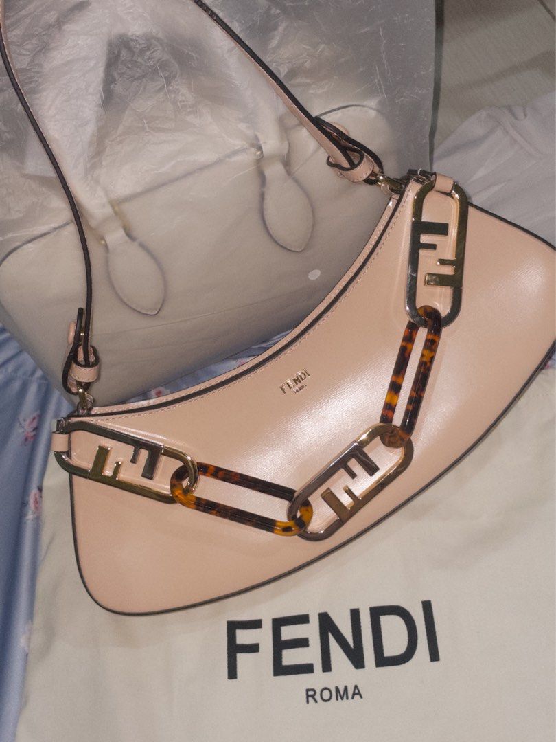 Fendi Roma Baguette Bag (Category: Luxury Bags & Wallets) located in Manila. Submitted by kristelleluxxe (Listing ID 1402223526, Image 2). Description: - Quality Fendi Baguette - Soft pink color - Unique chain detail with Fendi logo - Top handle - Zip closure - Interior pocket - Made in Italy.
