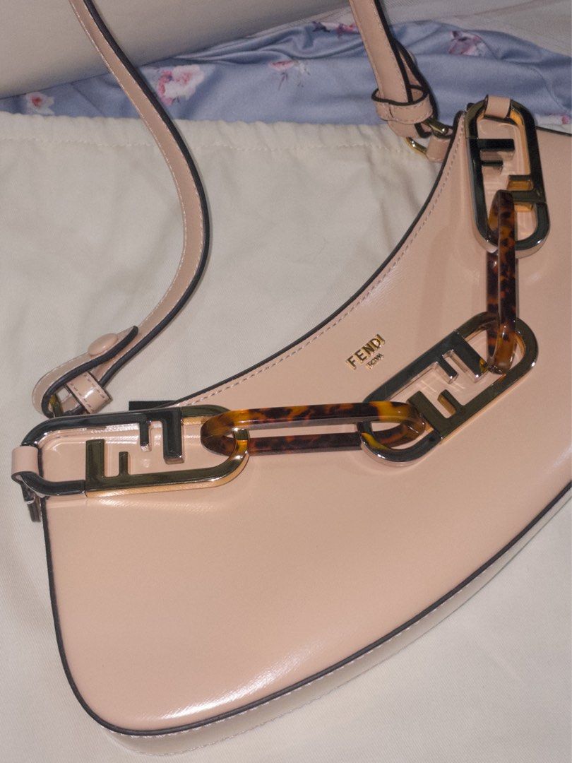 Fendi Roma Baguette Bag (Category: Luxury Bags & Wallets) located in Manila. Submitted by kristelleluxxe (Listing ID 1402223526, Image 3). Description: - Quality Fendi Baguette - Soft pink color - Unique chain detail with Fendi logo - Top handle - Zip closure - Interior pocket - Made in Italy.