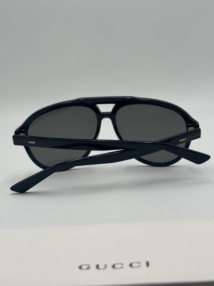 Gucci Aviator Sunglasses (Category: Sunglasses & Eyewear) located in Quezon City. Submitted by _cmluxephilippines (Listing ID 1402211968, Image 2). Description: SUPER SALE‼️NO CASE OR GENERIC CASE ‼️ Gucci GG1443S aviator sunglasses, in a black and grey colorway. They feature a recycled acetate frame with solid tinted nylon lenses and the Gucci logo on the temples. This model is designed with a masculine pilot shape and offers 100% UVA/UVB protec