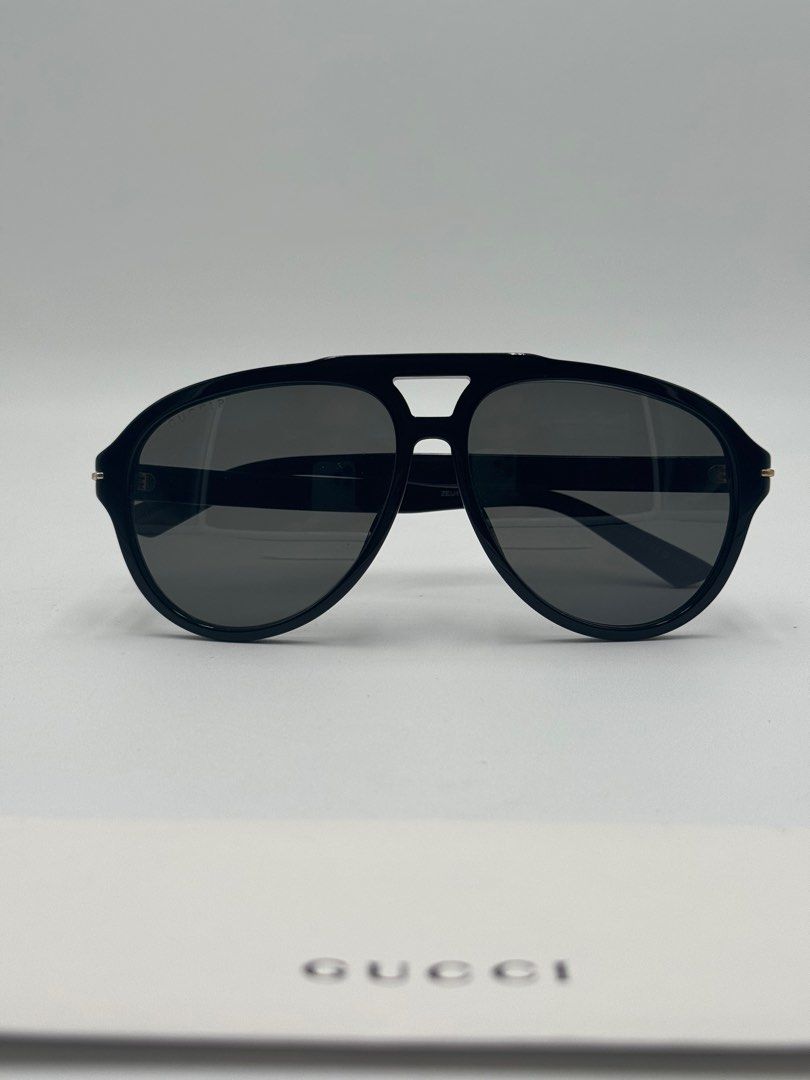 Gucci Aviator Sunglasses (Category: Sunglasses & Eyewear) located in Quezon City. Submitted by _cmluxephilippines (Listing ID 1402211968, Image 1). Description: SUPER SALE‼️NO CASE OR GENERIC CASE ‼️ Gucci GG1443S aviator sunglasses, in a black and grey colorway. They feature a recycled acetate frame with solid tinted nylon lenses and the Gucci logo on the temples. This model is designed with a masculine pilot shape and offers 100% UVA/UVB protec