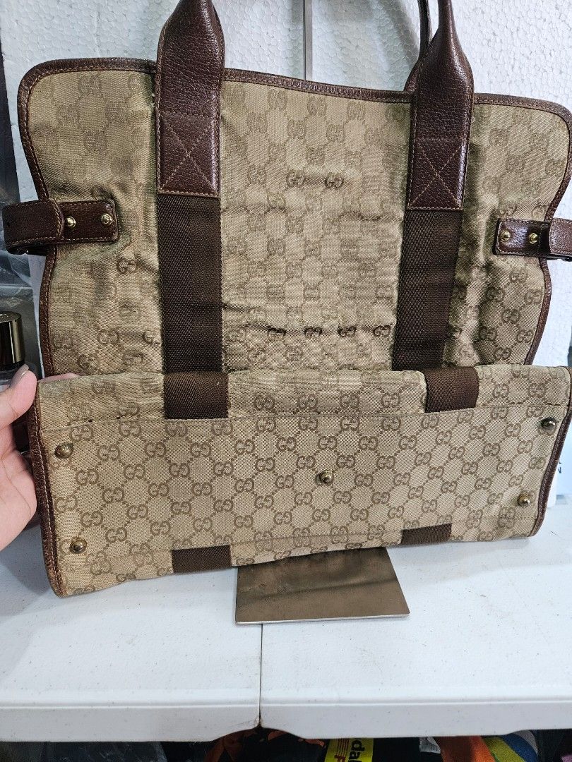 Gucci GG Canvas Tote Bag (Category: Luxury Bags & Wallets) located in Quezon City. Submitted by bags4ever (Listing ID 1402254063, Image 3). Description: Authentic Gucci tote bag featuring the iconic GG canvas pattern. It has brown leather accents and handles. The interior includes a zippered pocket and a leather tag with Gucci branding. The bag has a classic design with a durable construction..