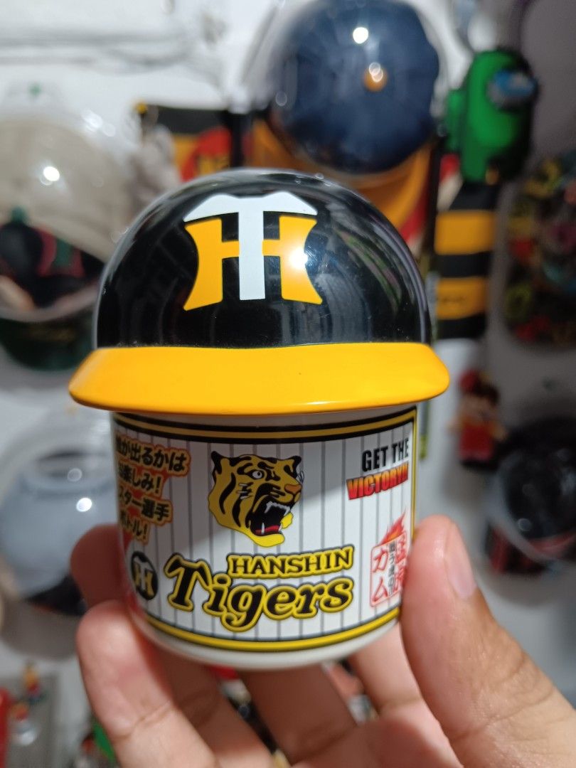 Hanshin Tigers Baseball Team Collectible (Category: Vintage Collectibles) located in Manila. Submitted by roshisneakerhouse (Listing ID 1402126829, Image 1). Description: Hanshin Tigers collectible item. It features the team's logo and colors. It has Japanese text on it. The item is likely a promotional or souvenir item related to the Hanshin Tigers baseball team. No issue Courier:Lalamove/Grab Express/J&T PM lang po.