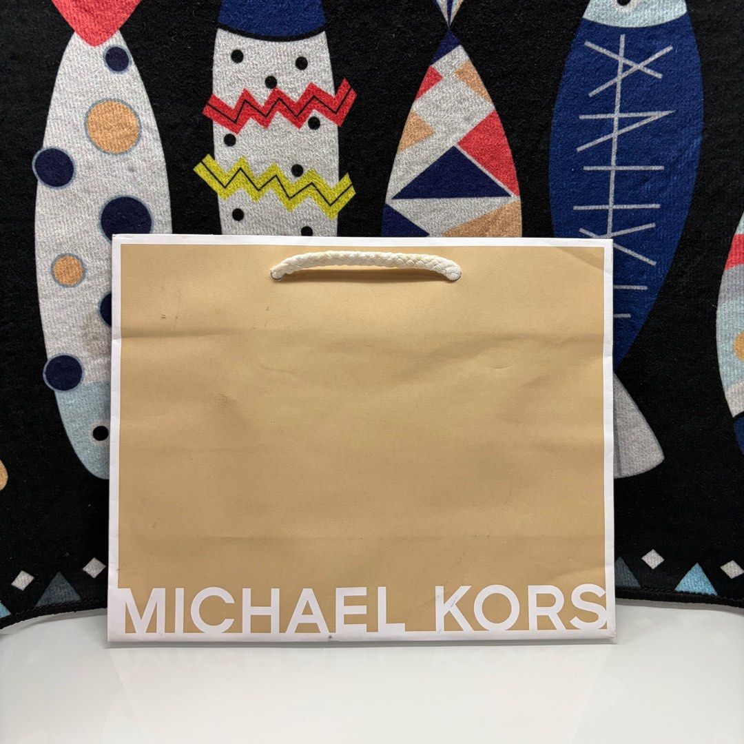 Michael Kors Paper Bag (Category: Luxury Bags & Wallets) located in Manila. Submitted by urbanwear (Listing ID 1402220190, Image 1). Description: - Authentic Michael Kors paper bag - Features a beige exterior - White Michael Kors logo - White rope handle - Perfect for gifting - Great for storing Michael Kors items.