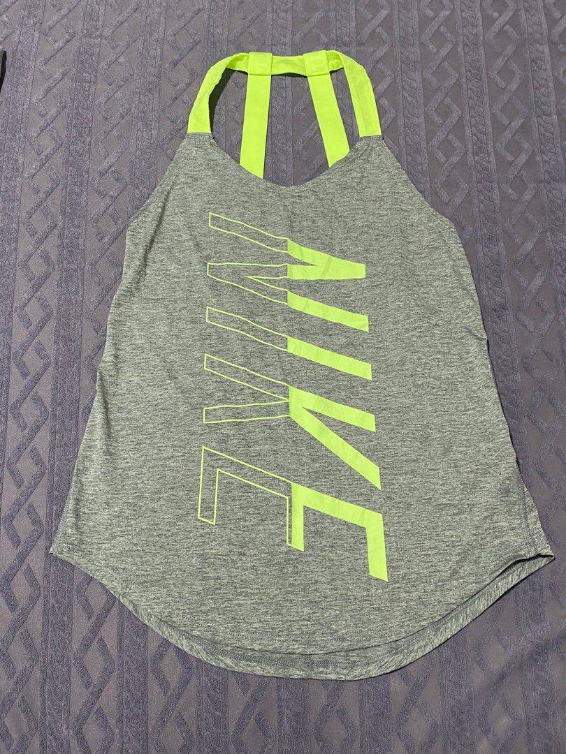 Nike Dri-FIT Tank Top - XS (Category: Activewear) located in San Narciso. Submitted by prelovedbentables (Listing ID 1402121348, Image 1). Description: - Nike Dri-FIT tank top - Gray with neon green accents - Features Nike logo - Unique back strap design - Size: XS - Made in Thailand.
