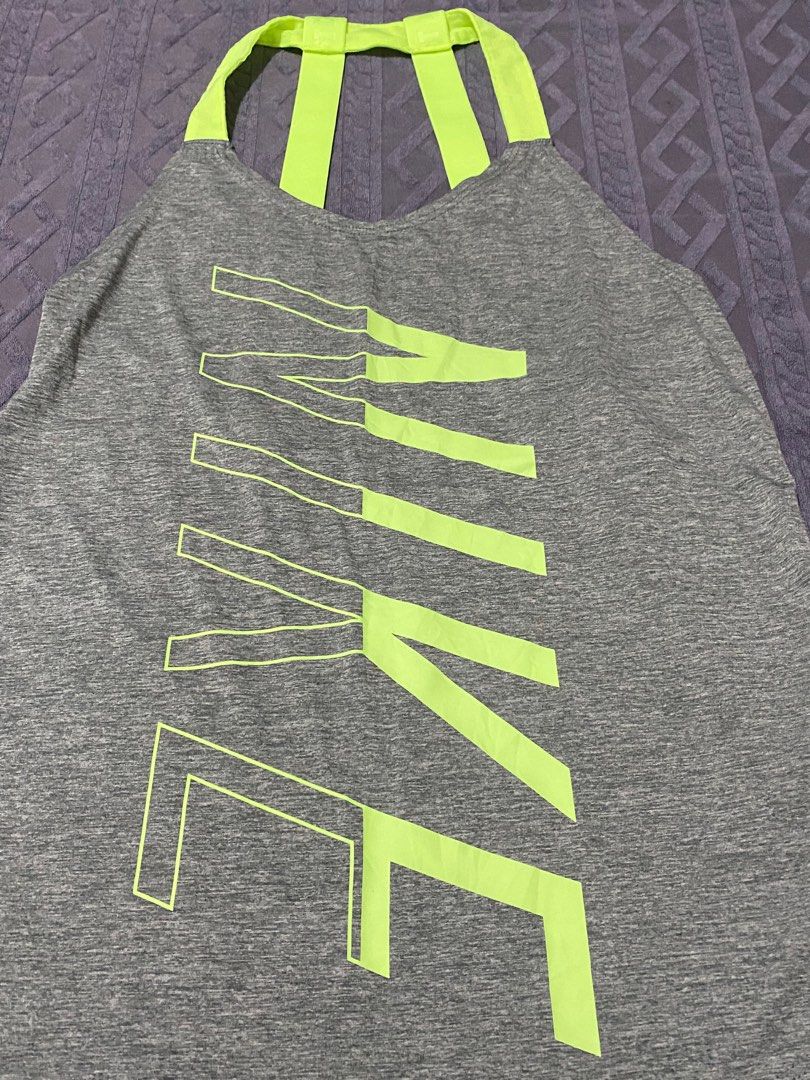 Nike Dri-FIT Tank Top - XS (Category: Activewear) located in San Narciso. Submitted by prelovedbentables (Listing ID 1402121348, Image 2). Description: - Nike Dri-FIT tank top - Gray with neon green accents - Features Nike logo - Unique back strap design - Size: XS - Made in Thailand.