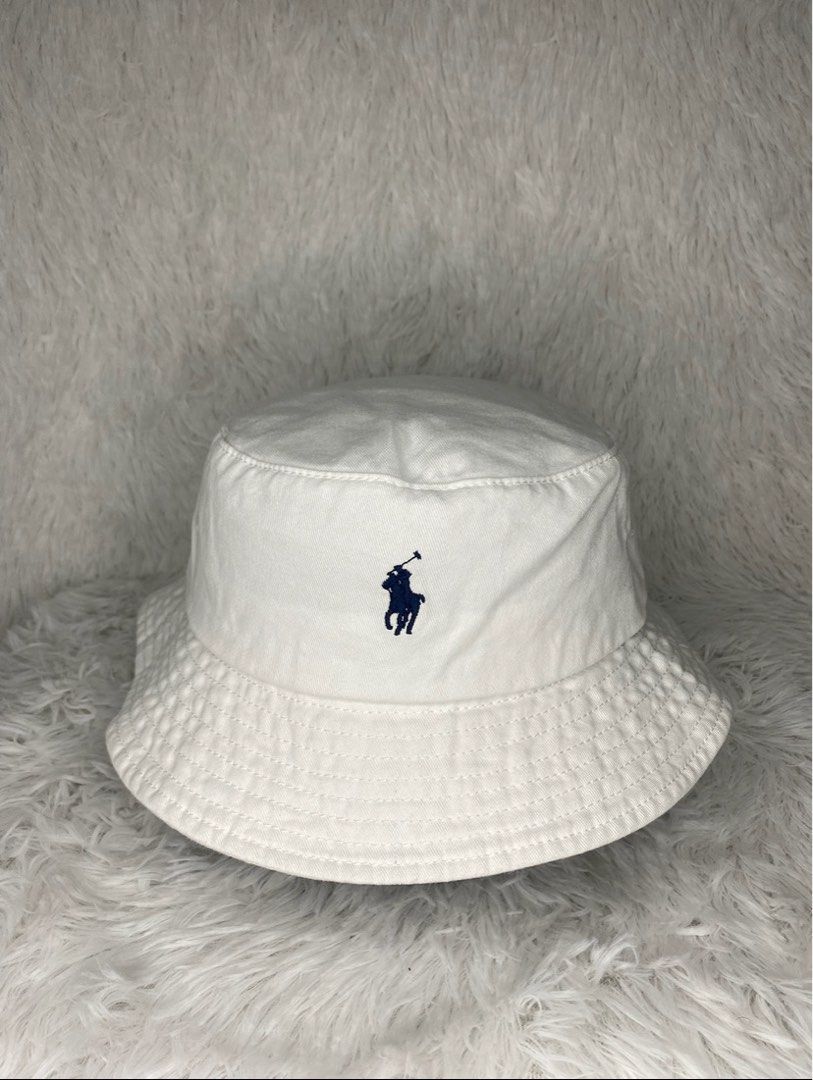 Polo Ralph Lauren White Bucket Hat (Category: Hats & Beanies) located in Batangas. Submitted by lifehitz.ph (Listing ID 1402255979, Image 1). Description: Polo Ralph Lauren bucket hat. Features the iconic Polo logo. Made of cotton. Classic and versatile..