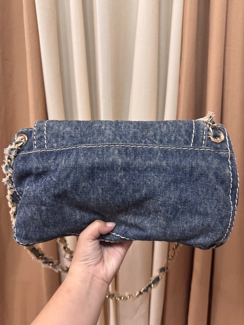 Prada Denim (Category: Luxury Bags & Wallets) located in Rodriguez. Submitted by PrelovedbyMelz (Listing ID 1402267642, Image 3). Description: - Prada denim shoulder bag. - Features a stylish denim design. - Includes a chain strap. - Showcases the iconic Prada logo. - In good condition..