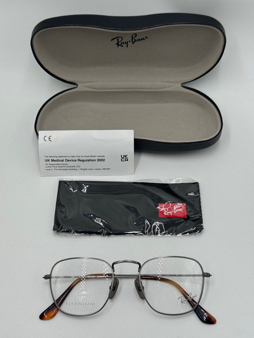 Ray-Ban Titanium Eyeglasses (Category: Sunglasses & Eyewear) located in Quezon City. Submitted by _cmluxephilippines (Listing ID 1402136881, Image 1). Description: Ray-Ban Frank Titanium Eyeglasses The glasses in the image are identified as the Ray-Ban Frank Titanium Optics eyeglasses. They are a unisex style featuring a square shape and a frame made of lightweight and durable titanium. Product Details Model Name: Frank Titanium Optics Model Code