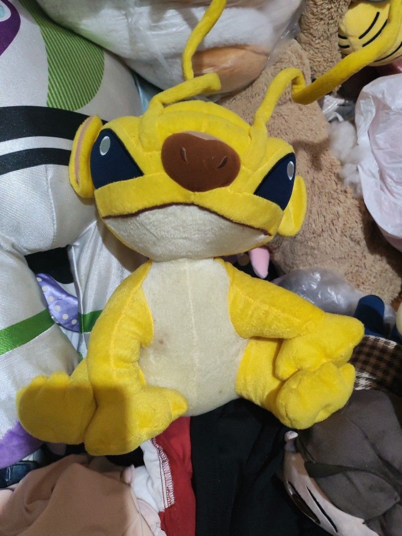 Yellow Stitch Plush Toy sparky (Category: Plushies & Soft Toys) located in Manila. Submitted by welllovess (Listing ID 1402251389, Image 1). Description: - Adorable yellow Stitch plush toy. - Features Stitch's large ears, blue eyes, and brown nose. - In a sitting position with extended arms and legs. - Medium size, ideal for cuddling or display. -With freebies and free sf.